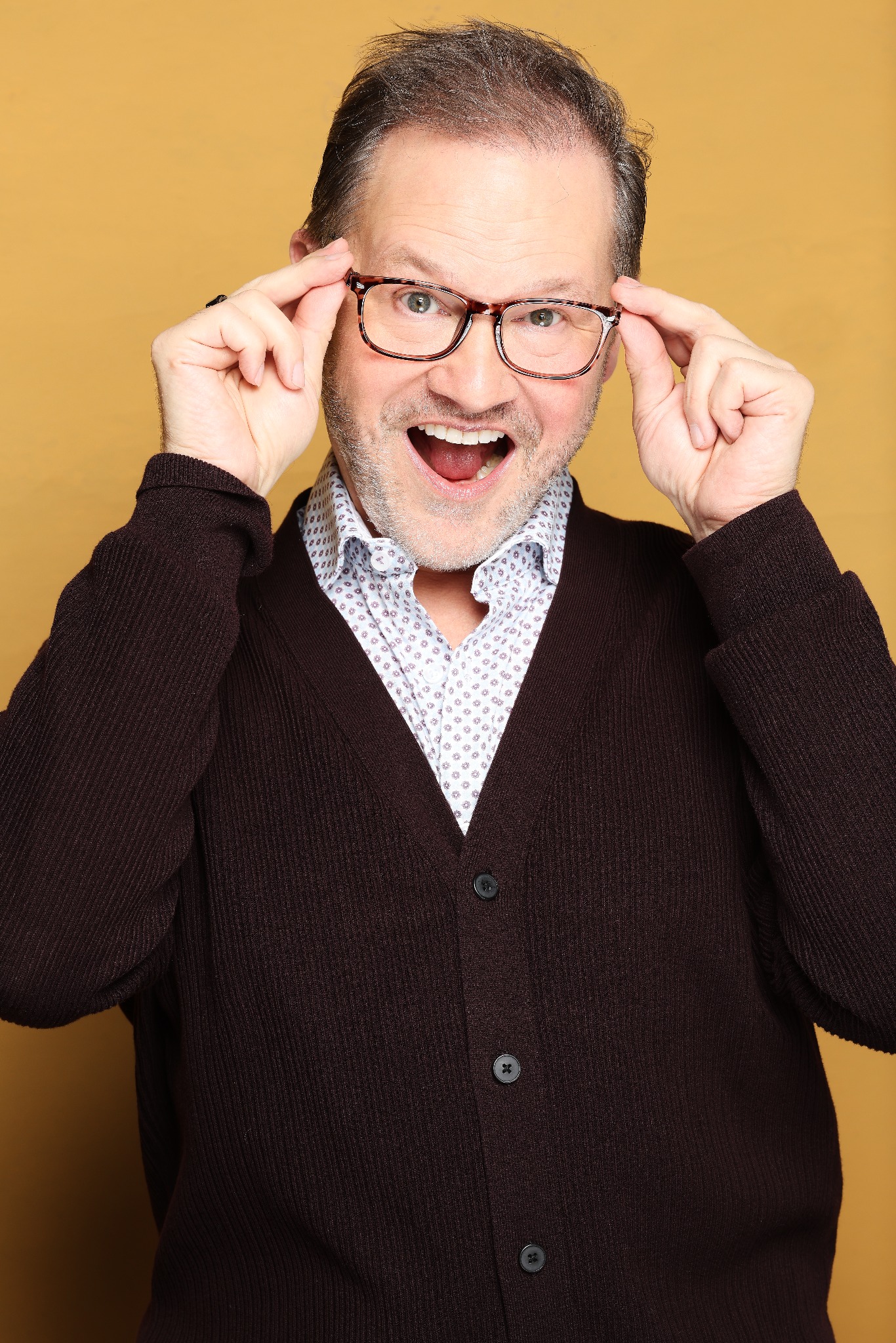 Harry Clark making an animated comic expression while wearing glasses